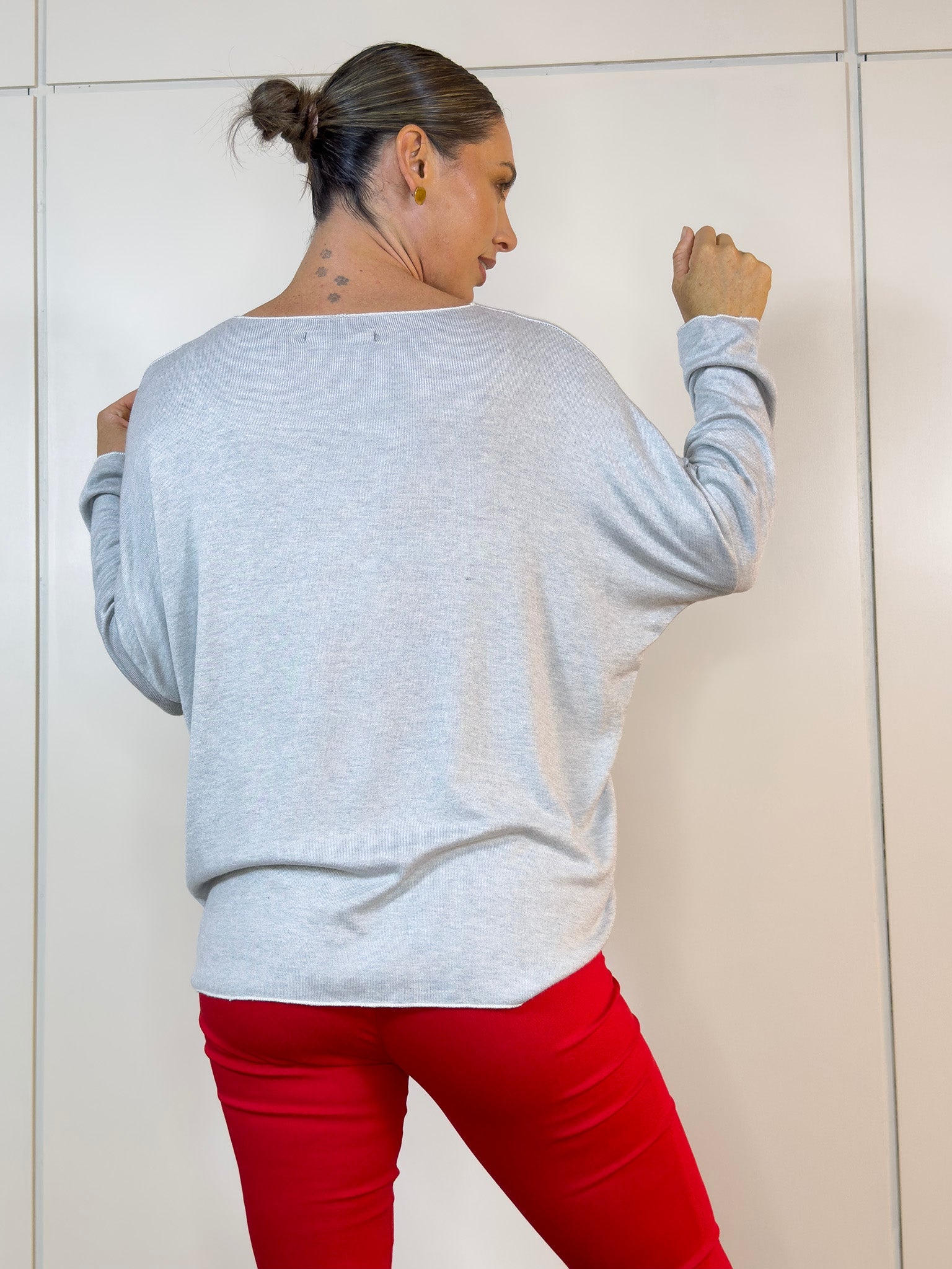 Detalle de la textura suave y caída del buzo en gris